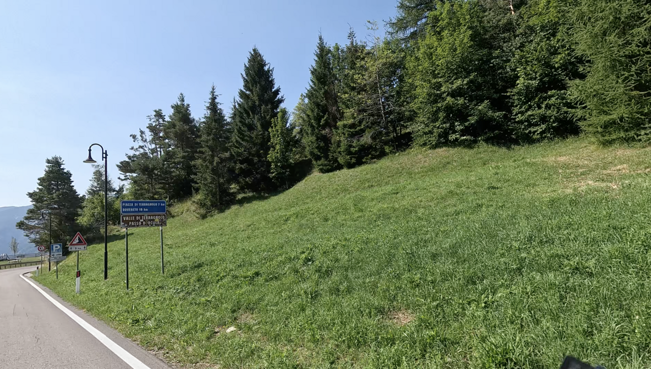 Bereits kurz oberhalb der Ortschaft Serrada steht ein offizielles Passschild zum Passo Borcola. Obwohl die Nordrampe erst 7 Kilometer später mit der Ortschaft Terragnolo beginnt.